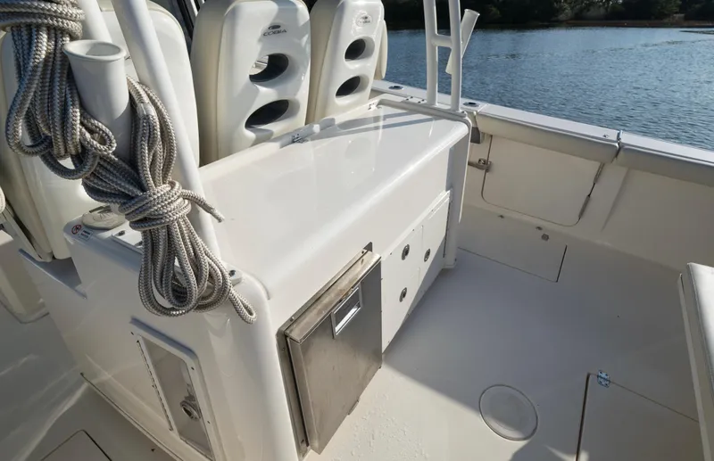 Nauti Builder Yacht Photos Pics 2022 Cobia 350 Center Console boat interior with seating and storage, near water.