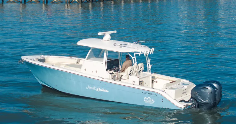 Nauti Builder Yacht Photos Pics 2022 Cobia 350 Center Console boat cruising on calm blue water.