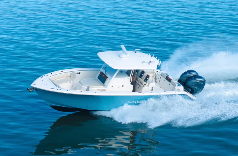 Nauti Builder Yacht Photos Pics 2022 Cobia 350 Center Console boat speeding on open water.
