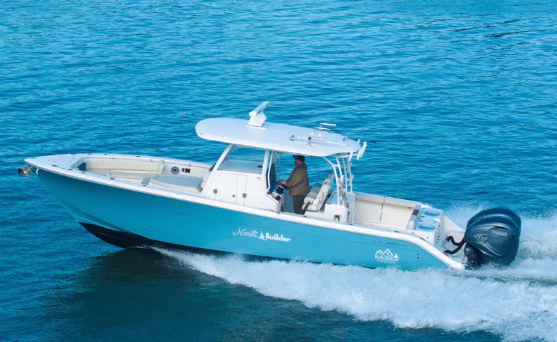 Nauti Builder Yacht Photos Pics 2022 Cobia 350 Center Console boat cruising on blue water.