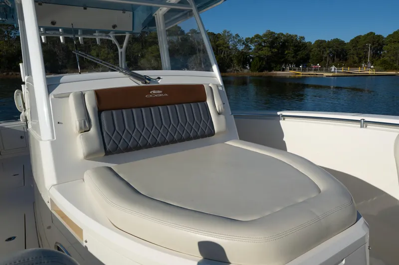 Nauti Builder Yacht Photos Pics 2022 Cobia 350 Center Console boat with cushioned seating, docked by a scenic lake.
