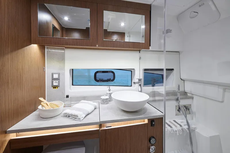  Yacht Photos Pics Manufacturer Provided Image: Modern bathroom in 2022 Jeanneau Leader 12.5 WA boat with sleek design and ocean view.
