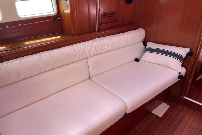  Yacht Photos Pics Interior of 2001 Beneteau Oceanis 411 yacht with white leather seating and wooden finish.