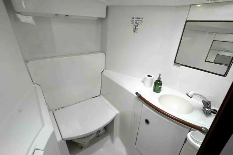  Yacht Photos Pics Bathroom of 2001 Beneteau Oceanis 411 yacht with sink, mirror, and toilet.