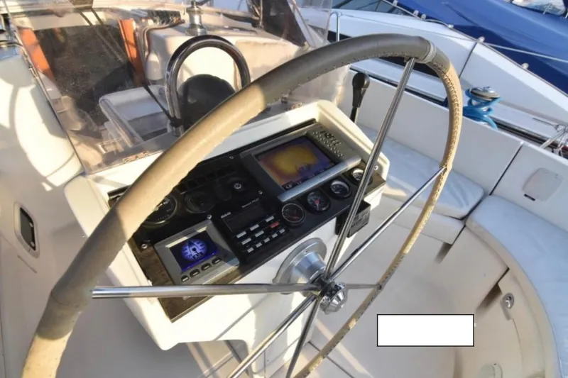 Yacht Photos Pics Steering wheel and control panel of 2001 Beneteau Oceanis 411 sailboat.