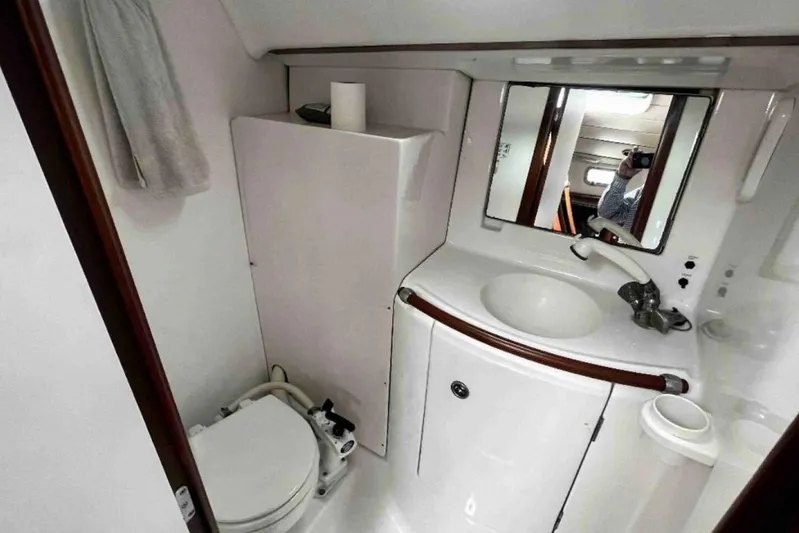  Yacht Photos Pics Bathroom interior of 2001 Beneteau Oceanis 411 yacht, featuring sink and toilet.