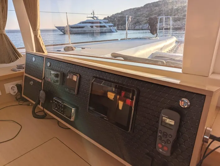  Yacht Photos Pics Interior view of a 2014 Lagoon 450 yacht with control panel and sea view.