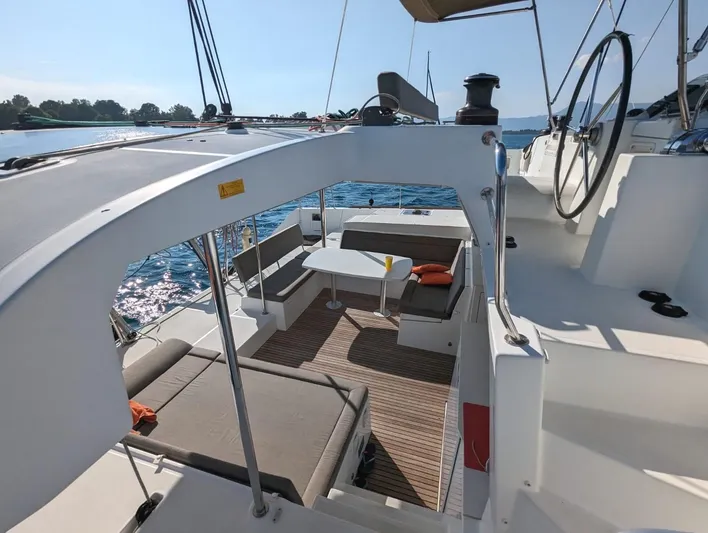  Yacht Photos Pics Lagoon 450 catamaran 2014 model with spacious deck and seating area on the water.