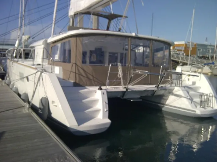  Yacht Photos Pics 2014 Lagoon 450 catamaran docked at marina, featuring spacious deck and modern design.
