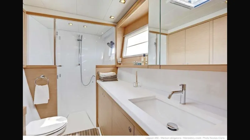  Yacht Photos Pics Luxurious bathroom in 2014 Lagoon 450 yacht, featuring modern fixtures and spacious shower.