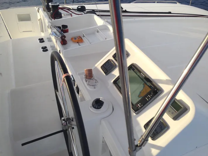  Yacht Photos Pics Helm station of 2014 Lagoon 450 catamaran with navigation instruments and steering wheel.
