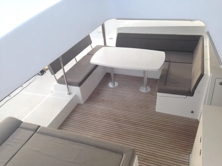  Yacht Photos Pics Spacious seating area on 2014 Lagoon 450 catamaran with cushioned benches and table.