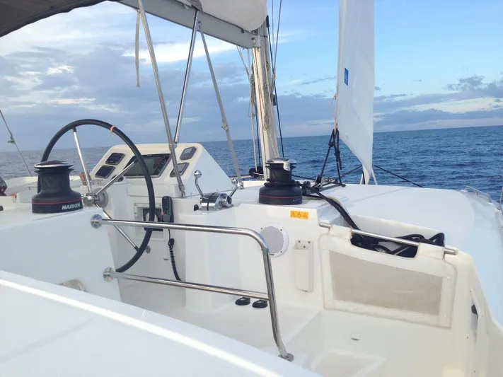  Yacht Photos Pics 2014 Lagoon 450 catamaran cockpit with steering wheel, winches, and ocean view.