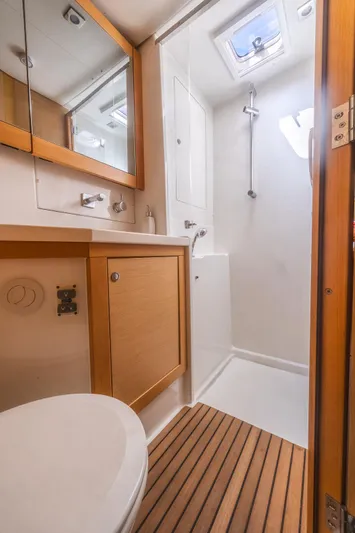  Yacht Photos Pics 2014 Lagoon 450 yacht bathroom with wooden accents and skylight.