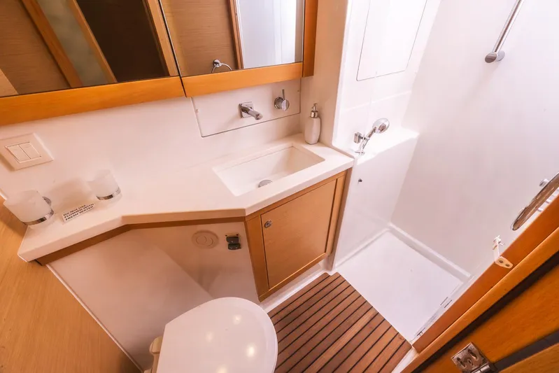  Yacht Photos Pics Luxurious bathroom in 2014 Lagoon 450 yacht with modern fixtures and wooden accents.