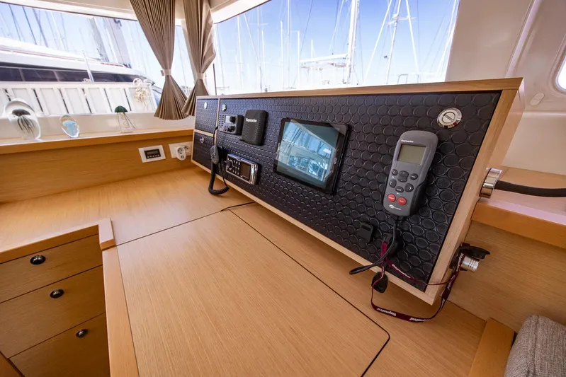  Yacht Photos Pics Interior view of a 2014 Lagoon 450 yacht's navigation station with control panel and equipment.
