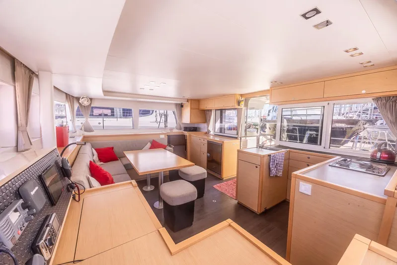  Yacht Photos Pics Interior of 2014 Lagoon 450 catamaran, featuring modern kitchen and dining area with ample seating.