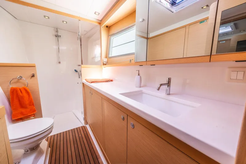  Yacht Photos Pics Luxurious bathroom in 2014 Lagoon 450 yacht with modern fixtures and wooden accents.