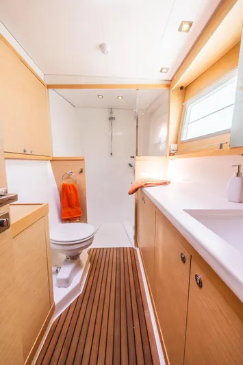  Yacht Photos Pics Luxurious bathroom in 2014 Lagoon 450 yacht with modern fixtures and wooden accents.