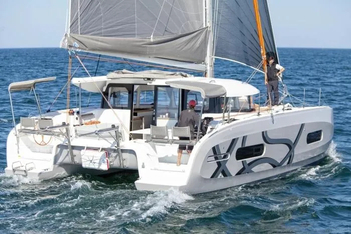  Yacht Photos Pics Manufacturer Provided Image: 2026 Excess 11 catamaran sailing on open sea with crew onboard.