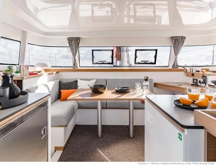  Yacht Photos Pics Manufacturer Provided Image: Modern interior of 2026 Excess 11 catamaran with dining area and kitchen.