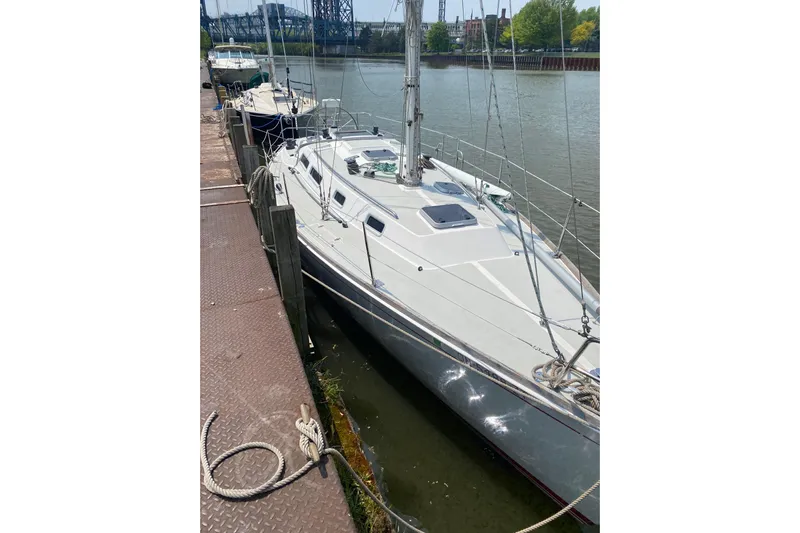 Grand Targee Yacht Photos Pics 1992 J Boats J/35 sailboat docked on a sunny day by the river.