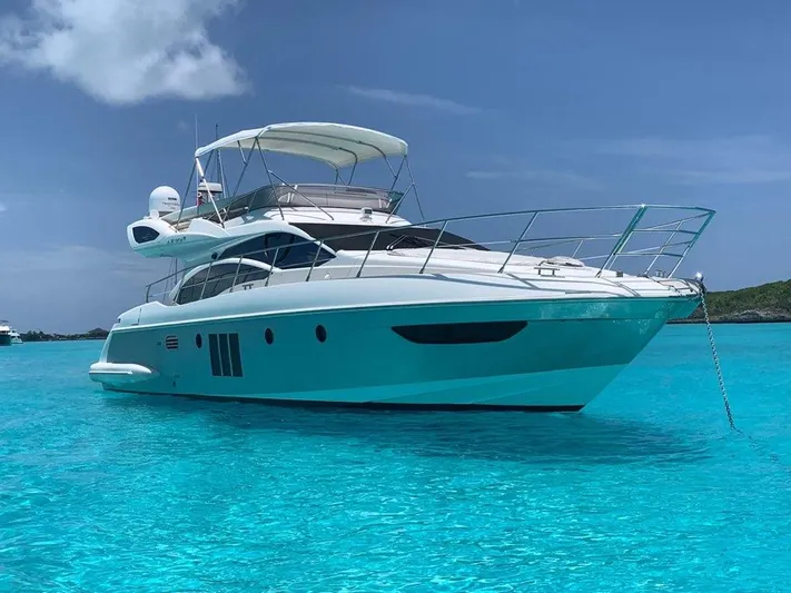  Yacht Photos Pics Luxury 2014 Azimut 48 yacht anchored in clear turquoise waters.