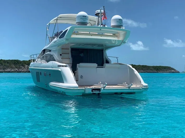  Yacht Photos Pics Luxury 2014 Azimut 48 yacht on clear turquoise water, scenic island backdrop.