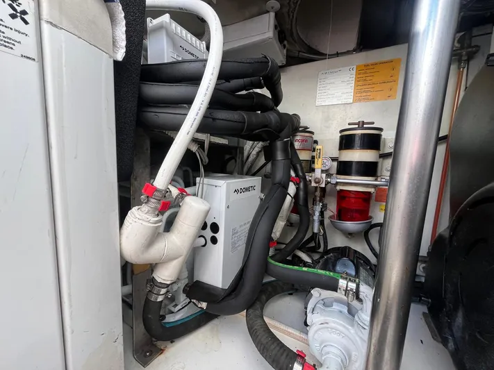  Yacht Photos Pics Engine room of a 2014 Azimut 48 yacht, featuring complex piping and machinery.