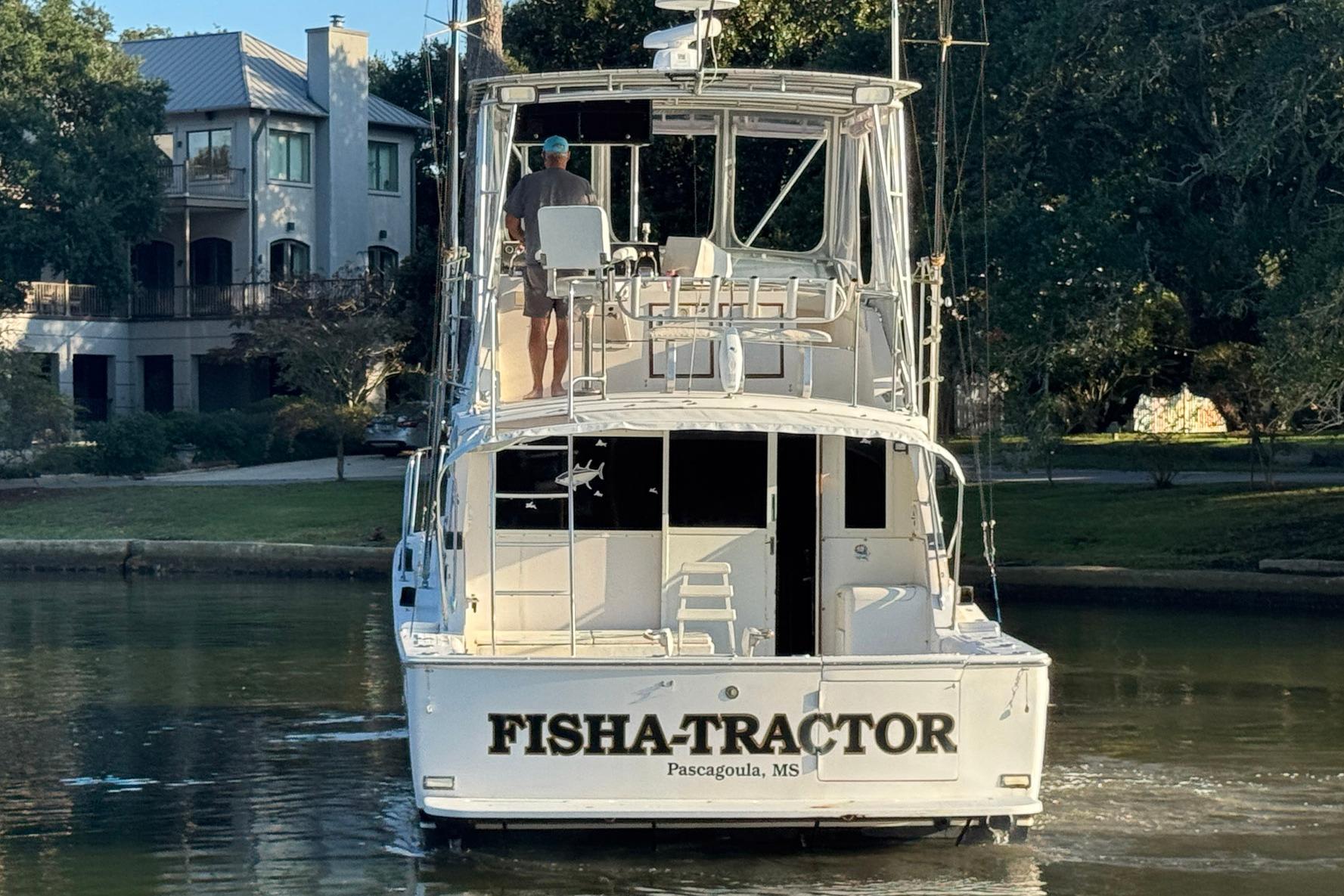 1979 Bertram 38 Convertible boat named "Fish Tractor" in a scenic waterway.