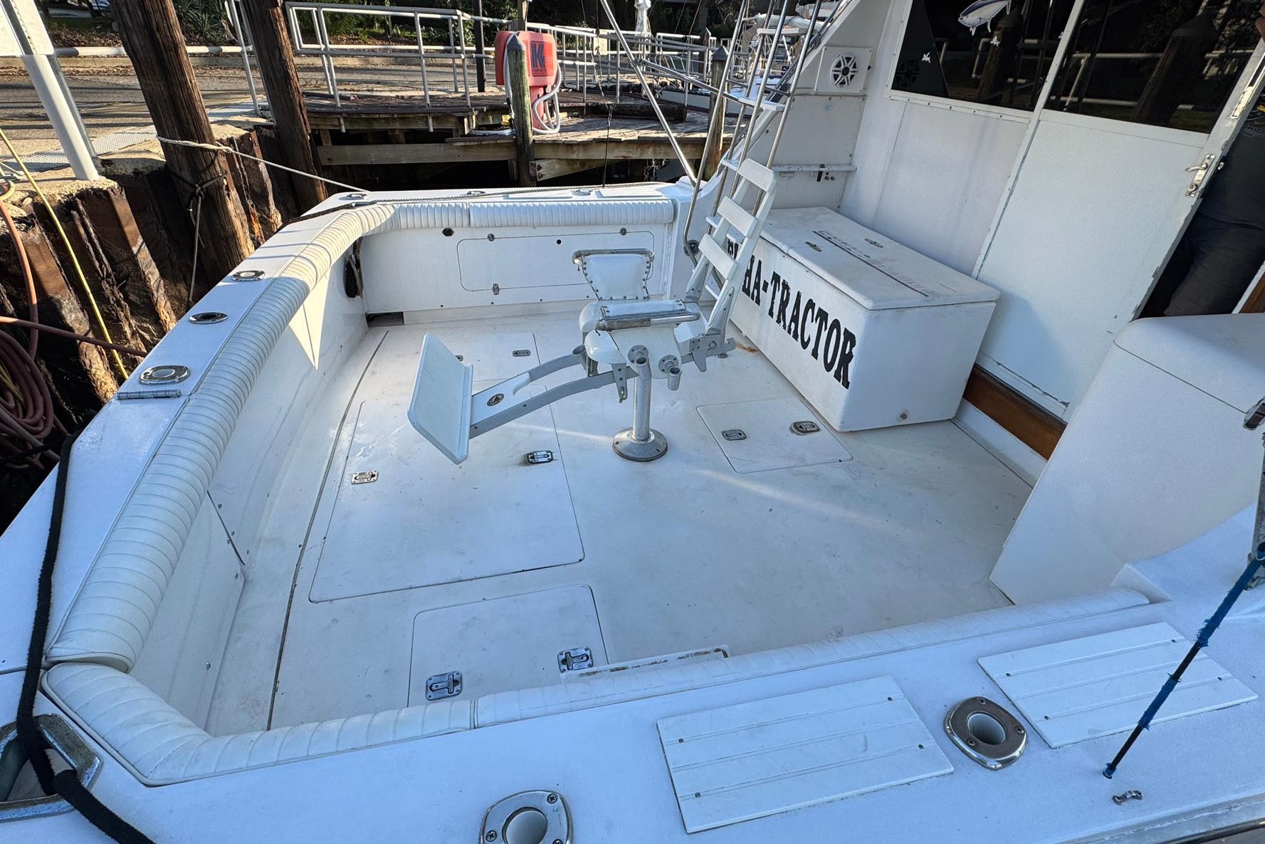 1979 Bertram 38 Convertible boat deck with fishing chair and storage box.
