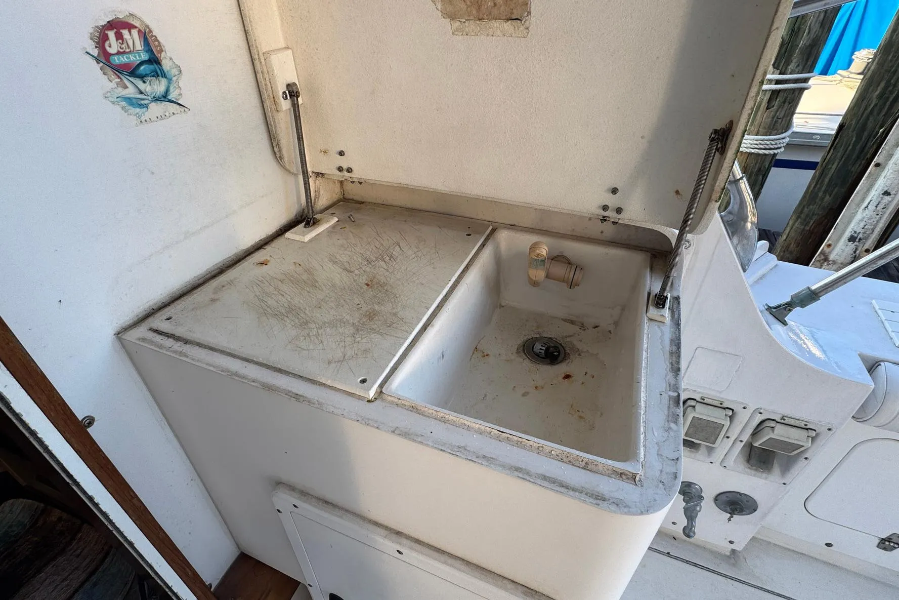 1979 Bertram 38 Convertible boat sink area with storage and faucet.