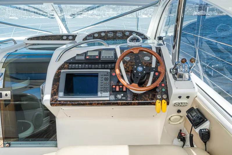  Yacht Photos Pics Helm of 2000 Fairline 48 Targa yacht with navigation equipment and wooden steering wheel.