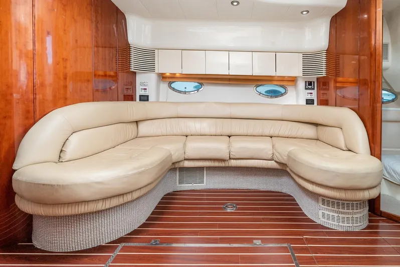  Yacht Photos Pics Luxurious interior of 2000 Fairline 48 Targa yacht with curved leather seating and wooden flooring.