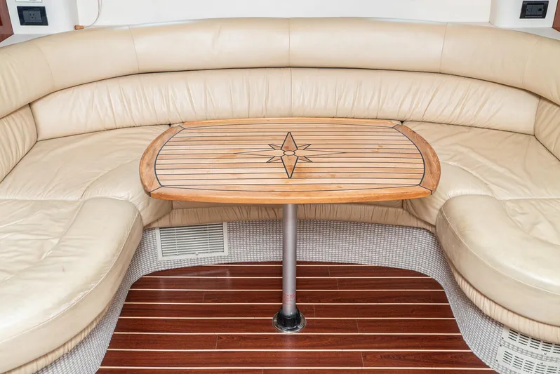  Yacht Photos Pics Fairline 48 Targa 2000 yacht interior with beige leather seating and wooden table.