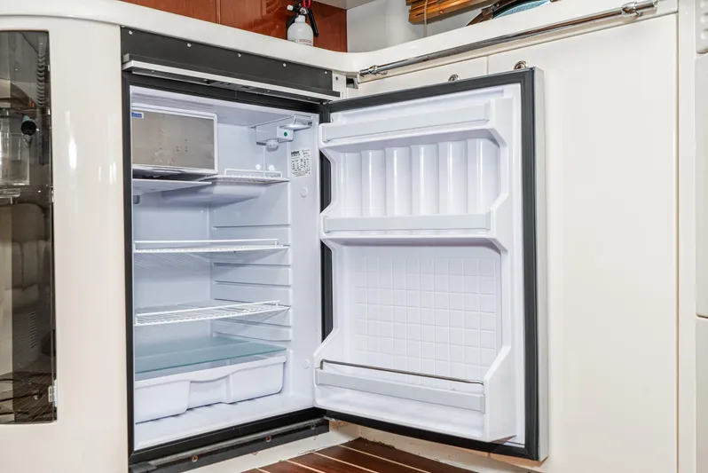  Yacht Photos Pics Open refrigerator on Fairline 48 Targa yacht, showcasing spacious interior and shelving.