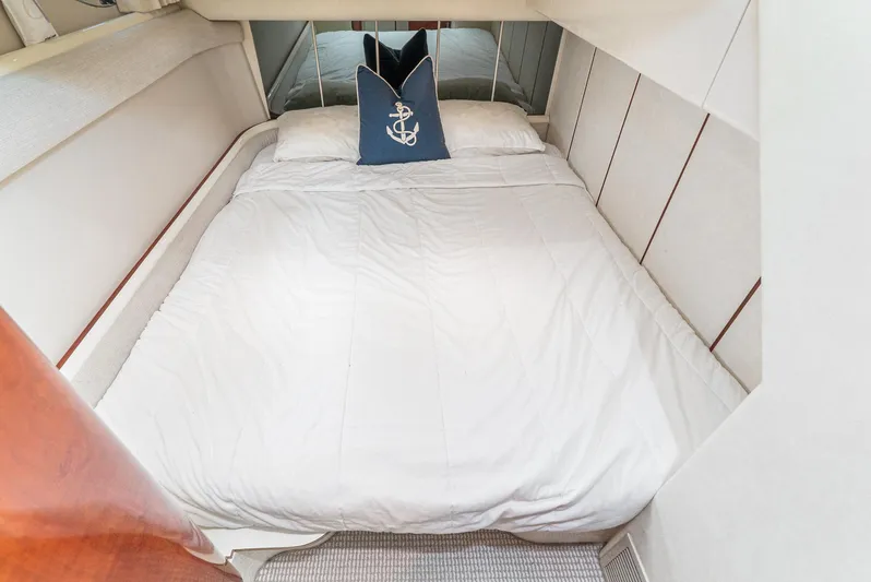  Yacht Photos Pics Cozy bedroom in 2000 Fairline 48 Targa yacht with white bedding and nautical pillow.