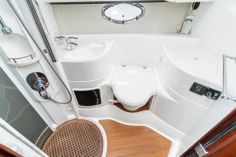  Yacht Photos Pics Luxurious bathroom in 2000 Fairline 48 Targa yacht with modern fixtures and wooden flooring.