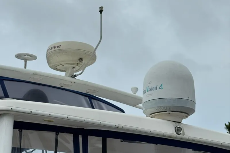 Just Blessed Yacht Photos Pics Radar and satellite equipment on a 2002 Silverton 43 Motor Yacht against a cloudy sky.
