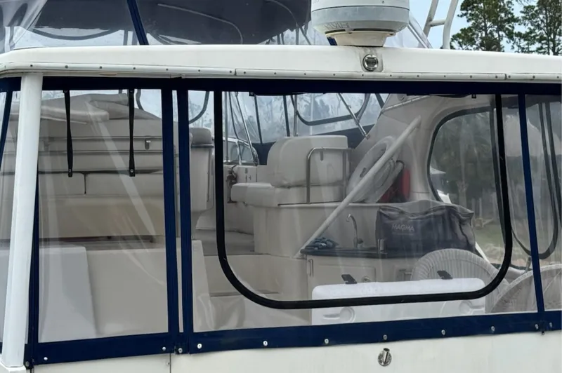 Just Blessed Yacht Photos Pics 2002 Silverton 43 Motor Yacht interior with clear enclosure and seating area.