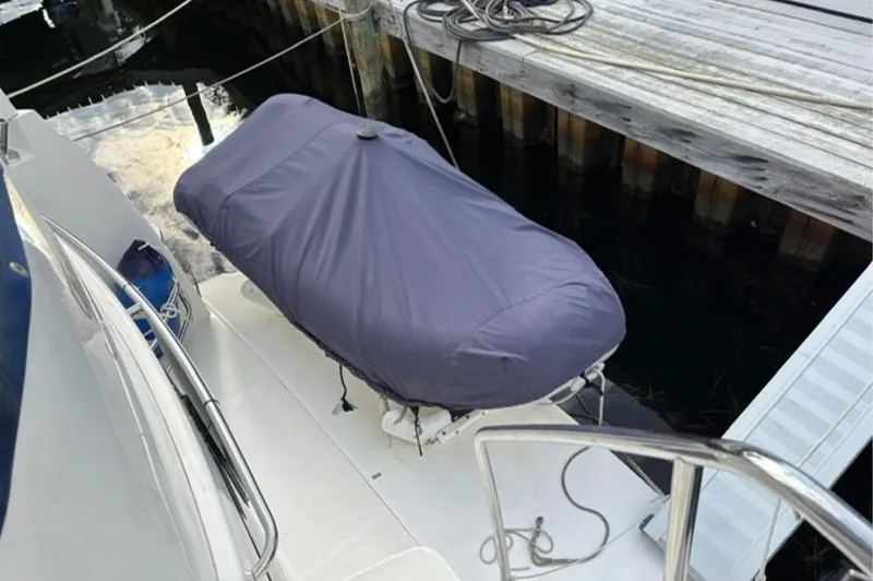 Just Blessed Yacht Photos Pics 2002 Silverton 43 Motor Yacht with covered equipment on deck, docked at marina.