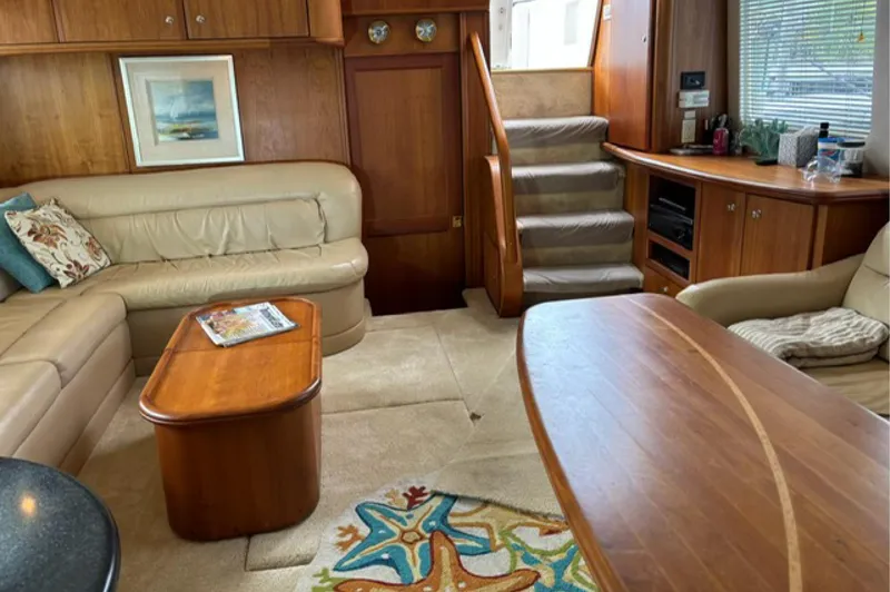 Just Blessed Yacht Photos Pics Interior of 2002 Silverton 43 Motor Yacht with plush seating and wooden furnishings.