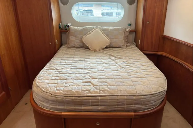 Just Blessed Yacht Photos Pics Cozy bedroom in 2002 Silverton 43 Motor Yacht with quilted bedding and wooden accents.