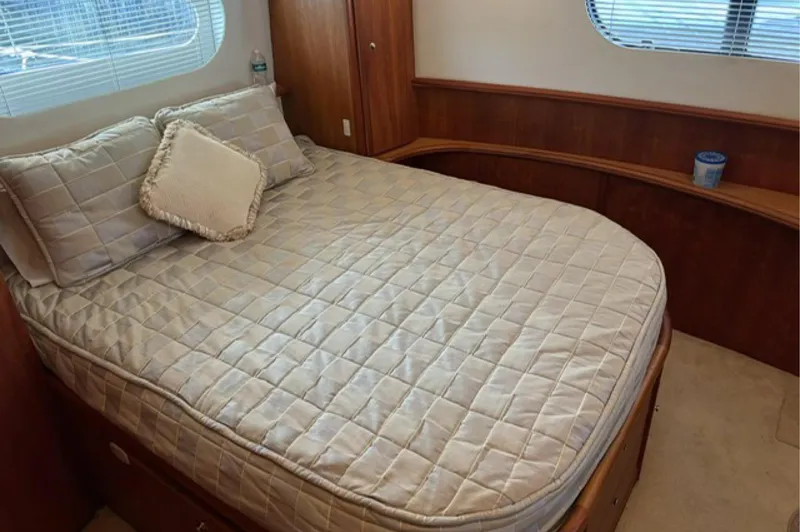 Just Blessed Yacht Photos Pics Cozy bedroom in 2002 Silverton 43 Motor Yacht with quilted bedding and wooden accents.