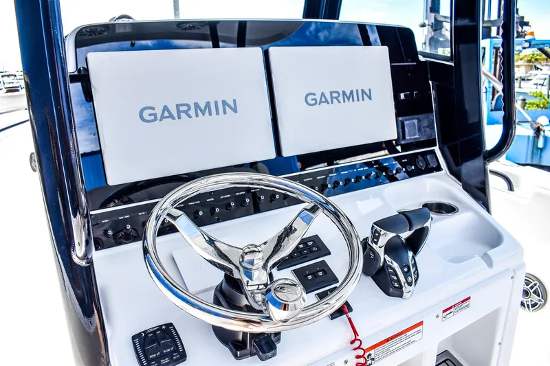  Yacht Photos Pics 2026 Sea Hunt Ultra 285 Coffin Box boat console with Garmin displays and steering wheel.