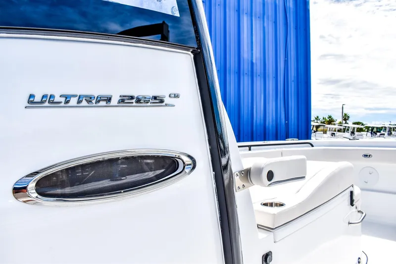  Yacht Photos Pics 2026 Sea Hunt Ultra 285 Coffin Box boat, sleek design with white seating and blue backdrop.