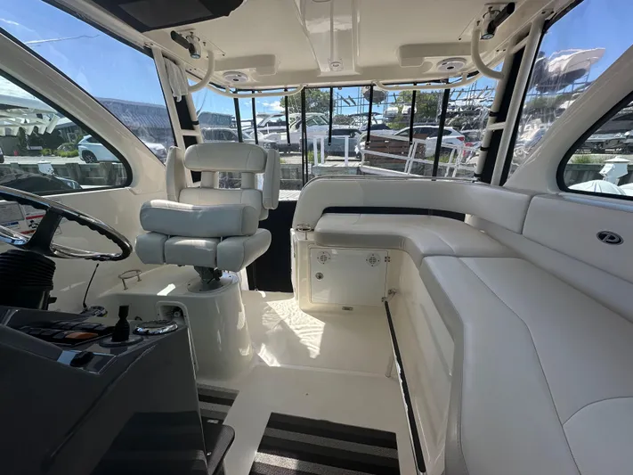  Yacht Photos Pics Interior of 2011 Pursuit OS 315 Offshore boat, featuring helm and seating area.