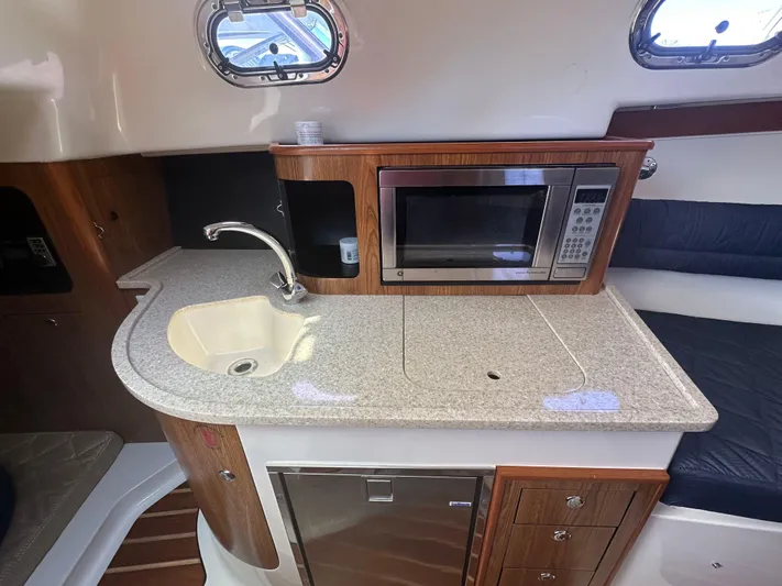  Yacht Photos Pics 2011 Pursuit OS 315 Offshore boat interior with sink, microwave, and countertop.
