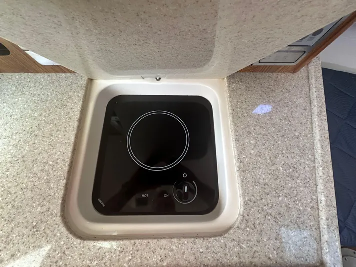  Yacht Photos Pics 2011 Pursuit OS 315 Offshore boat stove on a sleek countertop.