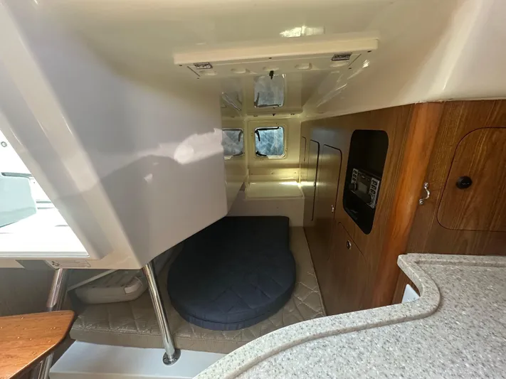  Yacht Photos Pics Interior cabin of 2011 Pursuit OS 315 Offshore boat, featuring a cozy sleeping area.